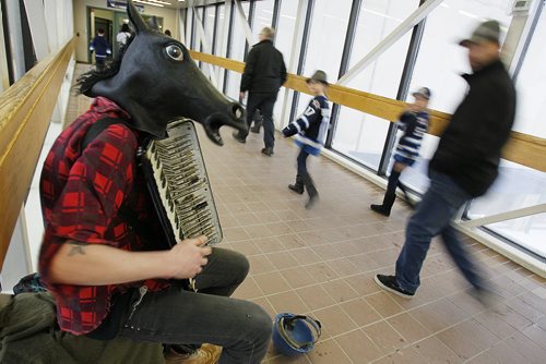 March 16, 2014 - 140316  -  Blaine the horse headed busker plays his music in a walkway prior to a Jet game Sunday, March 16, 2014. John Woods / Winnipeg Free Press.  Dave Sanderson story