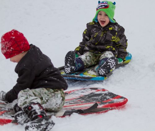 Jade Genaille, right, age 5, heads straight for a high-speed sledding crash into his younger brother, Jacob Genaille, age 4, while tobogganing with his family at The Forks Arctic Glacier Winter Park in Winnipeg on Tuesday, March 18, 2014. (Photo by Crystal Schick/Winnipeg Free Press)