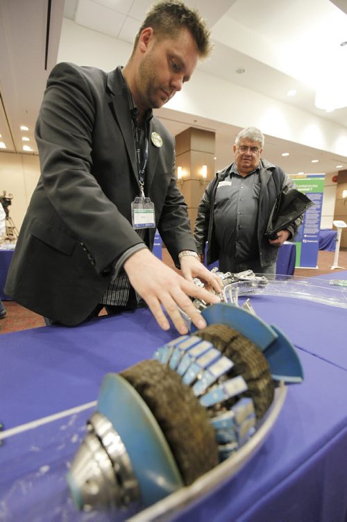 March 18, 2014 - 140318  -  Steve Loney, Aboriginal and Community Relations Liaison TransCanada, demonstrates an inline inspection tool to Gerald Merke from Prawda at an Energy East Pipeline open house Tuesday, March 18, 2014. John Woods / Winnipeg Free Press
