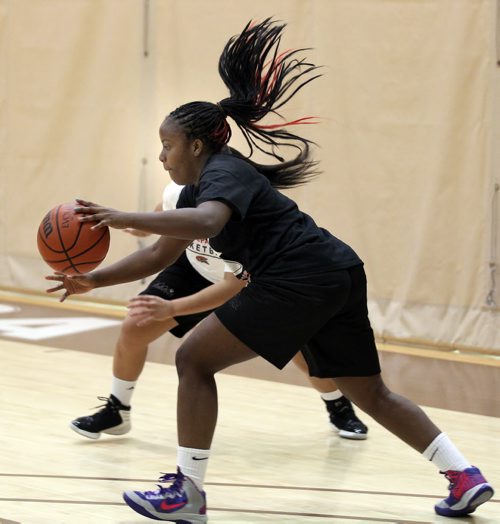 Sisler High's Kyanna Giles works around Sentilla Bubb at a team workout Tuesday evening. See Ed Tait story. March 18, 2014 - (Phil Hossack / Winnipeg Free Press)