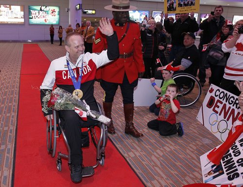 March 18, 2014 - 140318  -  Dennis Thiessen, gold medal curling Paralympian, is greeted by family and friends as he arrives at Winnipeg Airport Tuesday, March 18, 2014. John Woods / Winnipeg Free Press