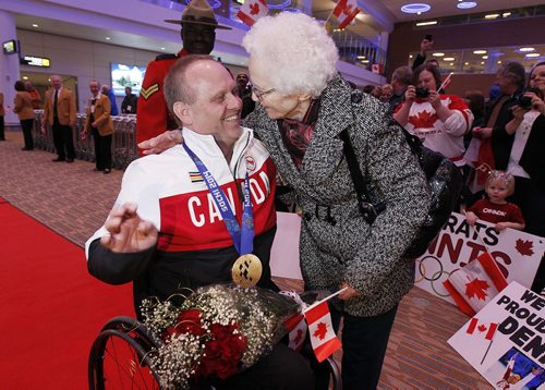 March 18, 2014 - 140318  -  Dennis Thiessen, gold medal curling Paralympian, is greeted by his mother Tina Thiessen as he arrives at Winnipeg Airport Tuesday, March 18, 2014. John Woods / Winnipeg Free Press