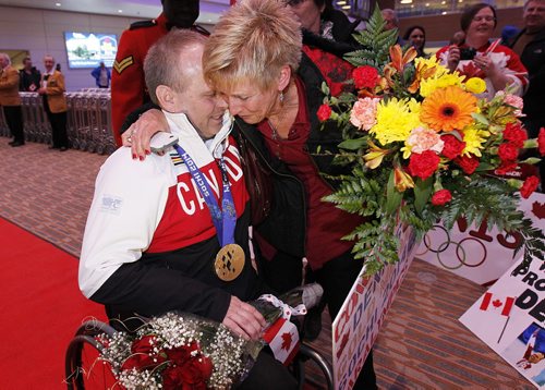 March 18, 2014 - 140318  -  Dennis Thiessen, gold medal curling Paralympian, is greeted by his sister Diana Dueck as he arrives at Winnipeg Airport Tuesday, March 18, 2014. John Woods / Winnipeg Free Press