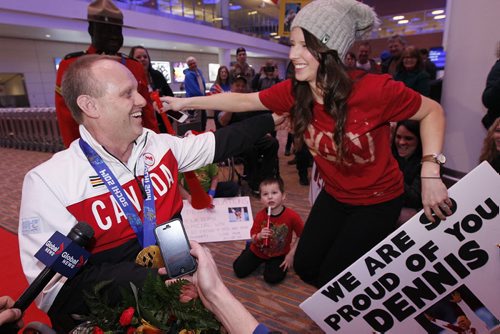 March 18, 2014 - 140318  -  Dennis Thiessen, gold medal curling Paralympian, is greeted by his daughter-in-law Rachel Thiessen as he arrives at Winnipeg Airport Tuesday, March 18, 2014. John Woods / Winnipeg Free Press