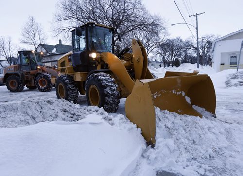 Stdup Snow Clearing continues in residential areas , in pic loaders and plows  work in the North End on Sgt. Tommy Prince St.  and Manitoba Ave,. keywords snow clearing ploughing  street cleaning  Mar. 19 2014 / KEN GIGLIOTTI / WINNIPEG FREE PRESS