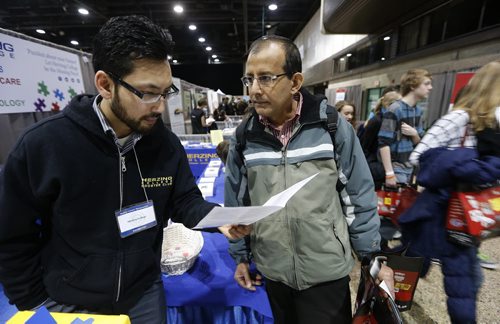 (right) 47 year old Ret Basnet is looking for work in the healthcare field , talks with (left) Hertzing College advisor   Sam Sar at Your Future Trending @ Rotary Career Symposium at the RBC Convention Centre Winnipeg in it's 17th year  and 131 schools participating with thousands of students  and adults attending , story by ashley prest Mar. 19 2014 / KEN GIGLIOTTI / WINNIPEG FREE PRESS