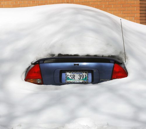 Honey I Found the Honda- A car appears from a giant snow drift on Burnell St in Winnipeg during todays 0C weather   Standup Photo- Mar 19, 2014   (JOE BRYKSA / WINNIPEG FREE PRESS)