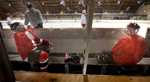 Dave Brown 62, (left) and Wayne Viznaugh (67) catch their breath as the group "takes ten" during their weekly scrimmage at the River Heights Community Club. March 4, 2014 - (Phil Hossack / Winnipeg Free Press)