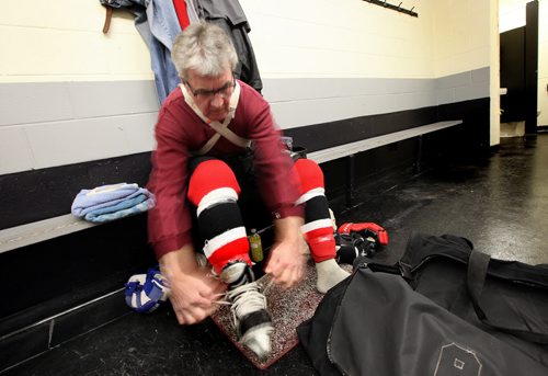Dave Brown (62) laces up his blades at the River Heights Corydon Community Center for an afternoon scrimmage. See story. March 4, 2014 - (Phil Hossack / Winnipeg Free Press)