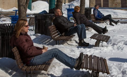 Sunbathers, left to right, Tara Campell, Eddie Terwisscha, Tara Higgins, and Michel Boileau, enjoy the view and weather from benches along the Assiniboine River at The Forks in Winnipeg on Wednesday, March 19, 2014. (Photo by Crystal Schick/Winnipeg Free Press)