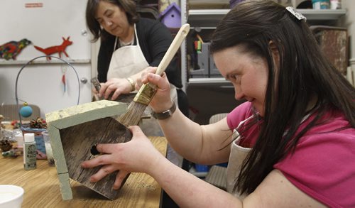 Finance. Karen Lehr paints a birdhouse for DASCH's The Scrap Came Back Upcycle Gift Store on St. Anne's Rd. The official opening was Wednesday.  Murray McNeill story.   Wayne Glowacki / Winnipeg Free Press March 19   2014