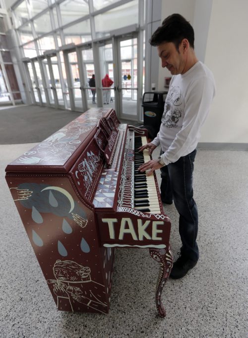 Stdup - Michel Fillion also known as Mayor Mitch because he intends to run for mayor in the next election plays one of the pianos placed in the downtown area as a public art project.Seven  pianos decorated by local artists are now in place in the downtown area as well as the airport  just in time for the Juno awards .The project Play Your Part invites the public to play the pianos  as an act of public art .  Mar. 20 2014 / KEN GIGLIOTTI / WINNIPEG FREE PRESS