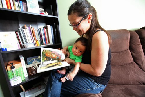 The Boldness Project - 49.8 section Wendy Hallgrimson and her partner James Zebrasky coddle  their 2 month old baby boy Lindal James coddle in their home in the North End.  Lindal is the first child to be a part of this new initiative to change the stats on literacy and health in First Nations children living in the North End. See story. March 20, 2014 Ruth Bonneville / Winnipeg Free Press