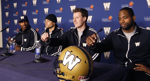 Winnipeg Blue Bombers players from right , wide receiver Cory Watson, quarterback Drew Willy, wide receiver  Nick Moore and defensive back Korey Banks get ready for the  press conference at Investors  Group Field Thursday.   Melissa Martin  story.    Wayne Glowacki / Winnipeg Free Press March 20   2014