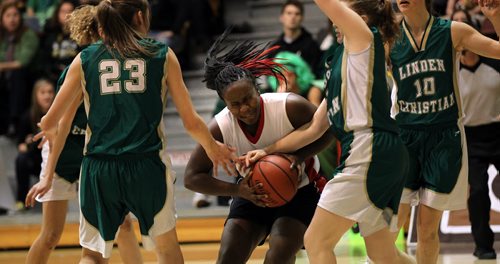 Sisler Spartan #11 Kyanna Giles drives through Linden Christain's defence in semi final action Thursday evening at U of M. See MMelisa Martin's story. March 20, 2014 - (Phil Hossack / Winnipeg Free Press)