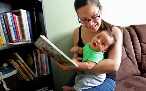 The Boldness Project - 49.8 section Wendy Hallgrimson, reads to her  2 month old baby boy Lindal Zebrasky.  Wendy Hallgrimson, her partner James Zebrasky coddle  and their 2 month old baby boy Lindal Zebrasky  are part of this new initiative to change the stats on literacy and health in First Nations children living in the North End. See story. March 20, 2014 Ruth Bonneville / Winnipeg Free Press