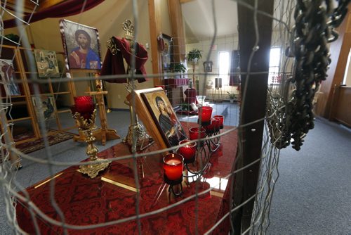 FAITH PAGE .Parishioners  at ST. Anne's Ukrainian Catholic church have created a display  that involves  putting chains and fencing around religious symbols  inside the church protesting Russian involvement  in Ukraine  and the burning of churches in Crimea . Story by Brenda Suderman    Mar. 21 2014 / KEN GIGLIOTTI / WINNIPEG FREE PRESS