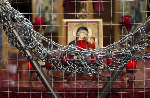 FAITH PAGE .Parishioners  at ST. Anne's Ukrainian Catholic church have created a display  that involves  putting chains and fencing around religious symbols  inside the church protesting Russian involvement  in Ukraine  and the burning of churches in Crimea . Story by Brenda Suderman    Mar. 21 2014 / KEN GIGLIOTTI / WINNIPEG FREE PRESS