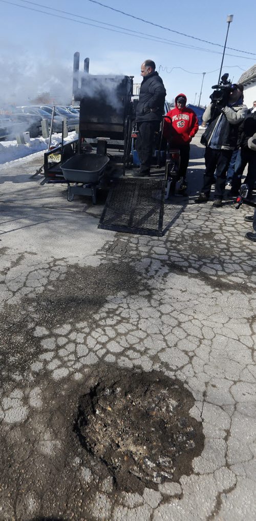 Pot Hole Repair -  Thunder Bird Restaurant, Pellet Patch sales rep Saverio Marra director of sales demonstrates  pot hole reapair technology using asphalt and rubber     and  the effectiveness of a hot-mix-asphalt patching compound that had good results in Flint, Mich. Mar. 21 2014 / KEN GIGLIOTTI / WINNIPEG FREE PRESS
