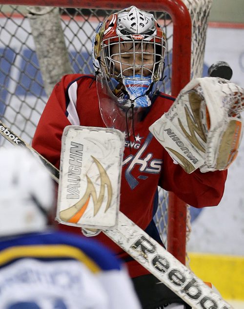 Sagkeeng Hawks goaltender, Joshua Seymour makes a save during a dramatic come from behind victoy during their Atom game against the OCN Blizzard during the 27th Annual Aboriginal Minor Hockey Tournament at MTS Iceplex, Saturday, March 22, 2014. Fifty-seven teams from more than 10 communities are represented. (TREVOR HAGAN/WINNIPEG FREE PRESS)