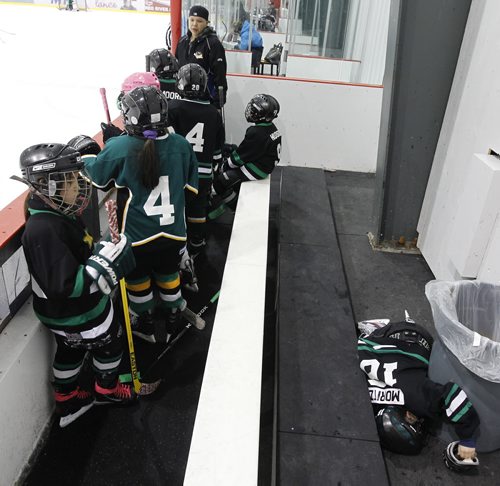 Norwway House's Aiden Moritz loses his balance and falls off the back of the bench during the teams Novice game against Cross Lake during the 27th Annual Aboriginal Minor Hockey Tournament at MTS Iceplex, Saturday, March 22, 2014. Fifty-seven teams from more than 10 communities are represented. (TREVOR HAGAN/WINNIPEG FREE PRESS)