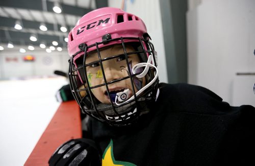 Norwway House's Shaylynn Chubb-Balfour smiles despite losing to Cross Lake in their Novice game during the 27th Annual Aboriginal Minor Hockey Tournament at MTS Iceplex, Saturday, March 22, 2014. Fifty-seven teams from more than 10 communities are represented. (TREVOR HAGAN/WINNIPEG FREE PRESS)
