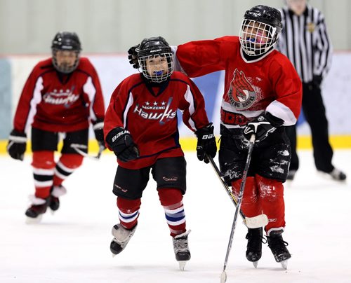 Julius Guimond and Peyton Moneyas of the Sagkeeng Hawks celebrate after Guimond scored to tie late in their Atom game against the OCN Blizzard during the 27th Annual Aboriginal Minor Hockey Tournament at MTS Iceplex, Saturday, March 22, 2014. Fifty-seven teams from more than 10 communities are represented. The Hawks would go on to win 6-5 in a thriller. (TREVOR HAGAN/WINNIPEG FREE PRESS)
