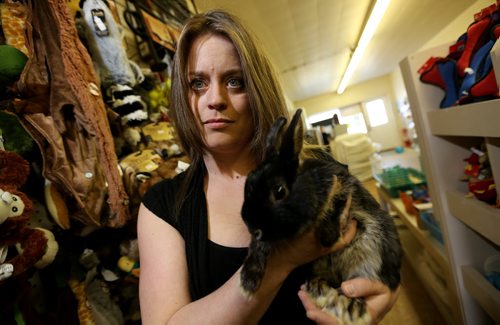 Tanya Morgan, owner of Pet Peripherals holding Peter, a rabbit, Sunday, March 23, 2014. The store has been without water for more than 30 days, and she has lost her groomer and much of her clientele. (TREVOR HAGAN/WINNIPEG FREE PRESS)