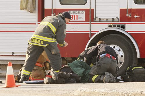 March 24, 2014 - 140324  -  Emergency crews attend to a pedestrian who was hit by a vehicle on Portage Avenue at Westwood Monday, March 24, 2014. John Woods / Winnipeg Free Press