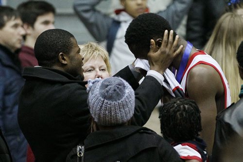 March 24, 2014 - 140324  -  Glenlawn Lions Sulaiman Jalloh (12) is comforted after being defeated by the St Paul's Crusaders in the MHSAA AAAA Provisional Basketball Championships at the University of Manitoba Monday, March 24, 2014. John Woods / Winnipeg Free Press