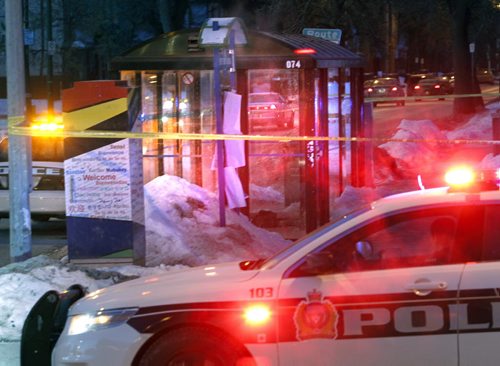 Two police cars parked at the intersection of  Maryland St. and Sargent Ave. along side a transit bus shelter that is taped off Tuesday morning.  Wayne Glowacki / Winnipeg Free Press March 25   2014
