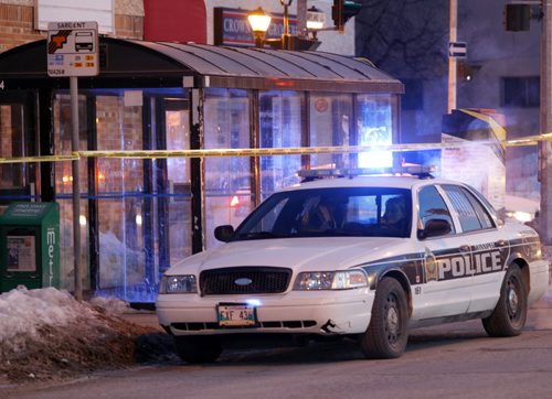 Two police cars parked at the intersection of  Maryland St and Sargent Ave. along side a transit bus shelter that is taped off Tuesday morning.  Wayne Glowacki / Winnipeg Free Press March 25   2014