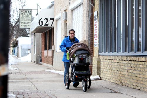 The Boldness Project - 49.8 section  Wendy Hallgrimson, walks along Selkirk Ave. with her  2 month old baby boy Lindal after doing business in the area.  Wendy and her partner James have lived in the area all their lives want their son to grow up healthy and proud of his roots. See story. March 20, 2014 Ruth Bonneville / Winnipeg Free Press