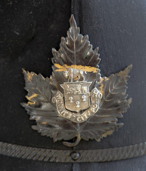 Oldest living Winnipeg police officer, soon-to-to-be 99-year-old Ken Hansell.- This is the badge on his original police helmet-See Gordon Sinclair story- Mar 25, 2014   (JOE BRYKSA / WINNIPEG FREE PRESS)