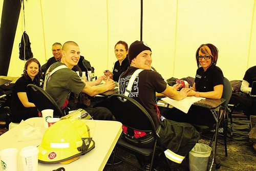 Canstar Community News (17/03/2014)- Firefighters raising money for muscular dystrophy. The ladies from strata spa treat the campers to mani-pedis firefighters from left Alan Bartley, and rookie campers Ben Ritchie and Mike Lisowick. (STEPHCROSIER/CANSTAR)