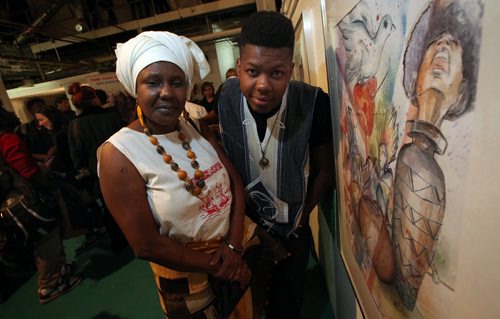 Artist Nelson Mutima poses with his mother (Henriette Mukesa - she was a nurse in Bukavu, Congo) at the Grafitti Gallery Wednesday evening. The "Peace Art Show" an art show exploring not only the resiliency of the people of the DRC, but also the similarities youth from around the world all share. In the Eastern Democratic Republic of Congo (DRC), repeated cycles of conflict have contributed to its unfortunate notoriety of being branded as the worst place in the world to be a woman.. See Carol Sanders story March 26, 2014 - (Phil Hossack / Winnipeg Free Press)