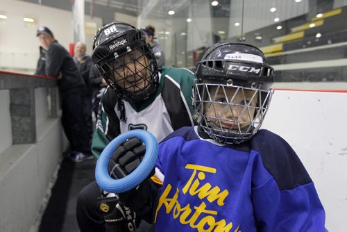 Western Canadian Ringette Championships opening ceremonies at the MTS Iceplex. 85 year old Alda Tait and 4 year old Keira Pattie pose for a photo. BORIS MINKEVICH / WINNIPEG FREE PRESS  March 26, 2014