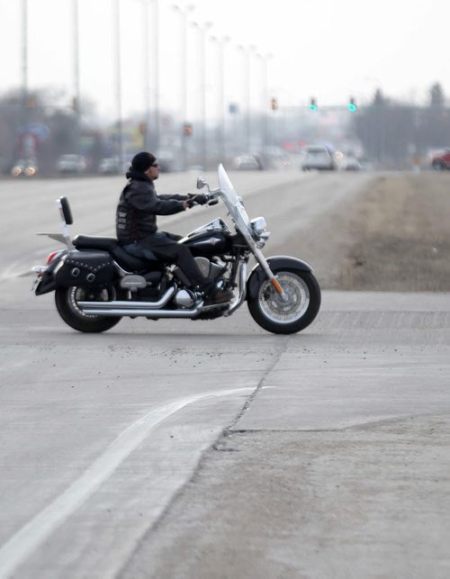 A motorcyclist hits the road in Watertown, South Dakota - See Randy Turner find spring story- March 26, 2014   (JOE BRYKSA / WINNIPEG FREE PRESS)