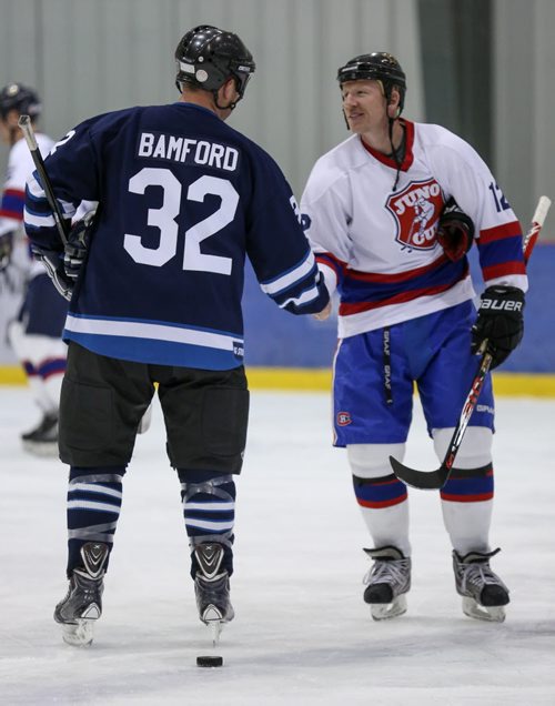 Gord Bamford, left, shakes hands with NHLer Mike Keane, during a practice for the JUNO Cup at the MTS Iceplex in Winnipeg on Thursday, March 27, 2014. (Photo by Crystal Schick/Winnipeg Free Press)