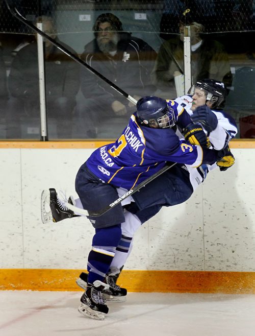 Winnipeg Blues defenceman #3Cody Danylchuk leans into Steinbach Piston Captain #24 Justin Augert Thursday evening in the third MJHL Playoff match between the teams in Steinbach. See Melissa Martin's story. March 27, 2014 - (Phil Hossack / Winnipeg Free Press)