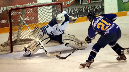 Steinbach Piston netminder #35 Nicholas Deery gets a toe on a shot from Winnipeg Blues #22 Garret Browning Thursday evening in the third MJHL Playoff match between the teams in Steinbach. See Melissa Martin's story. March 27, 2014 - (Phil Hossack / Winnipeg Free Press)
