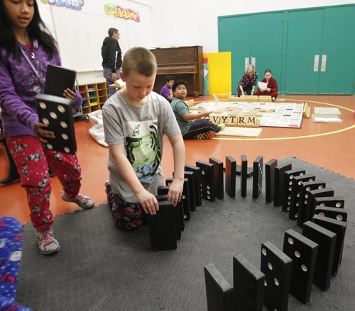 49.8 Intersection.  Lord Selkirk School grade 5 student Gage Richey plays with the big dominos.   For story on Sean Strachan,  the founder of Big Games, an enterprise that builds big games. Dave Sanderson story.   Wayne Glowacki / Winnipeg Free Press March 28   2014