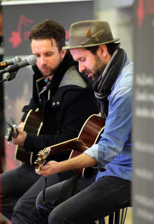 Left to right, Colin and John-Angus MacDonald of the Trews warm up during a sound check prior to a concert and presentation at Maples Collegiate Friday afternoon. See story/Release March 28, 2014 - (Phil Hossack / Winnipeg Free Press)  . BAND AID GRANTS ON MARCH 28  CANADIAN ROCKERS THE TREWS SET TO PERFORM LIVE FOR STUDENTS  DETAILS: MusiCounts continues to keep music alive in schools across Canada teaming up with Canadian rockers, The Trews, to present two local Winnipeg schools (Maples Collegiate and Lakewood School) with their 2014 Band Aid Grant of $10,000 each to fund their  music education programs. Colin MacDonald and John-Angus MacDonald of The Trews, will present the students with instruments purchased with the grant and will treat them to an exclusive acoustic performance. MusiCounts will also recognize the over $1,000,000  contributed to date through Sirius XM Canada.  Special guest speakers include Director of MusiCounts, Allan Reid; Andreanne Sasseville, Director CCD and Industry Relations, from Sirius XM and Minister of Canadian Heritage and Official Languages, The Honourable Shelly Glover.