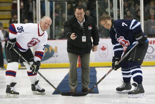 NHL Greats capitain  Mark Napier, left, Blue Rodeo Jim Cuddy, right, of team Rockers do ceremonial puck drop with CJOB Kelly Moore at the 11th annual Juno Cup at MTS iceplex Friday night-   Juno Standup- Mar 28, 2014   (JOE BRYKSA / WINNIPEG FREE PRESS)