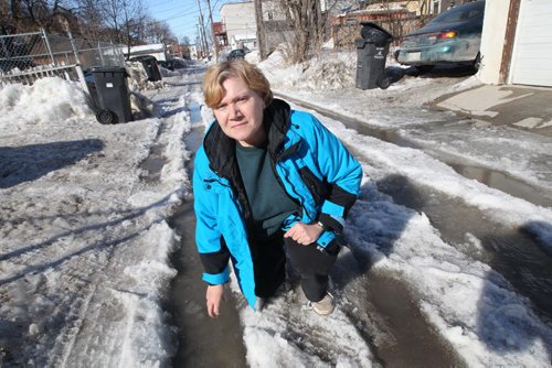 Maria Manu upset with city of Winnipeg for not plowing back lane on her Home St home -   See Adam Wazny story- Mar 28, 2014   (JOE BRYKSA / WINNIPEG FREE PRESS)
