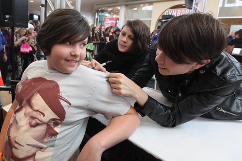 Ten year old May Mann gets her t-shirt signed by Canadian indie rock duo  Tegan (rear) and Sara  (signing) during the Juno Fanfare at St. Vital Centre Saturday.   March 29, 2014 Ruth Bonneville / Winnipeg Free Press