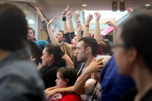 Music fans raise their hands to  dance on stage for a chance in winning tickets to the Juno's  at St. Vital Centre Saturday during the Juno FanFare.  March 29, 2014 Ruth Bonneville / Winnipeg Free Press