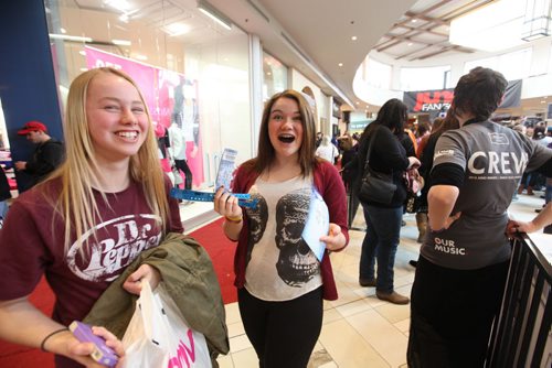 Sixteen year old Shianne Johnson can't hold back her excitement as she shows her friend Richelle Peters  (blond)   her winning tickets to the Juno's after winning a dance competition on stage at St. Vital Centre during Juno FanFare Saturday.  See story. March 29, 2014 Ruth Bonneville / Winnipeg Free Press
