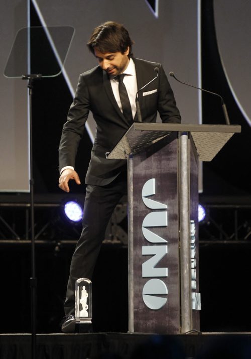Host Jian Ghomeshi puts Matt Mays' Rock Album of the Year award down on the stage as he was missing when he was called to receive it, at the 2014 Juno Gala at the Winnipeg Convention Centre, Saturday, March 29, 2014. Mays claimed he was backstage talking about surfing because he didn't expect to win. (TREVOR HAGAN/WINNIPEG FREE PRESS)