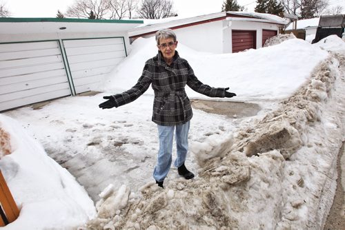 Susan McVarish, 68, who lives with her frail 88-year-old mother, has not been able to take the car out because of the windrow since the city plowed the back lane last Thursday.  140330 March 30, 2014 Mike Deal / Winnipeg Free Press